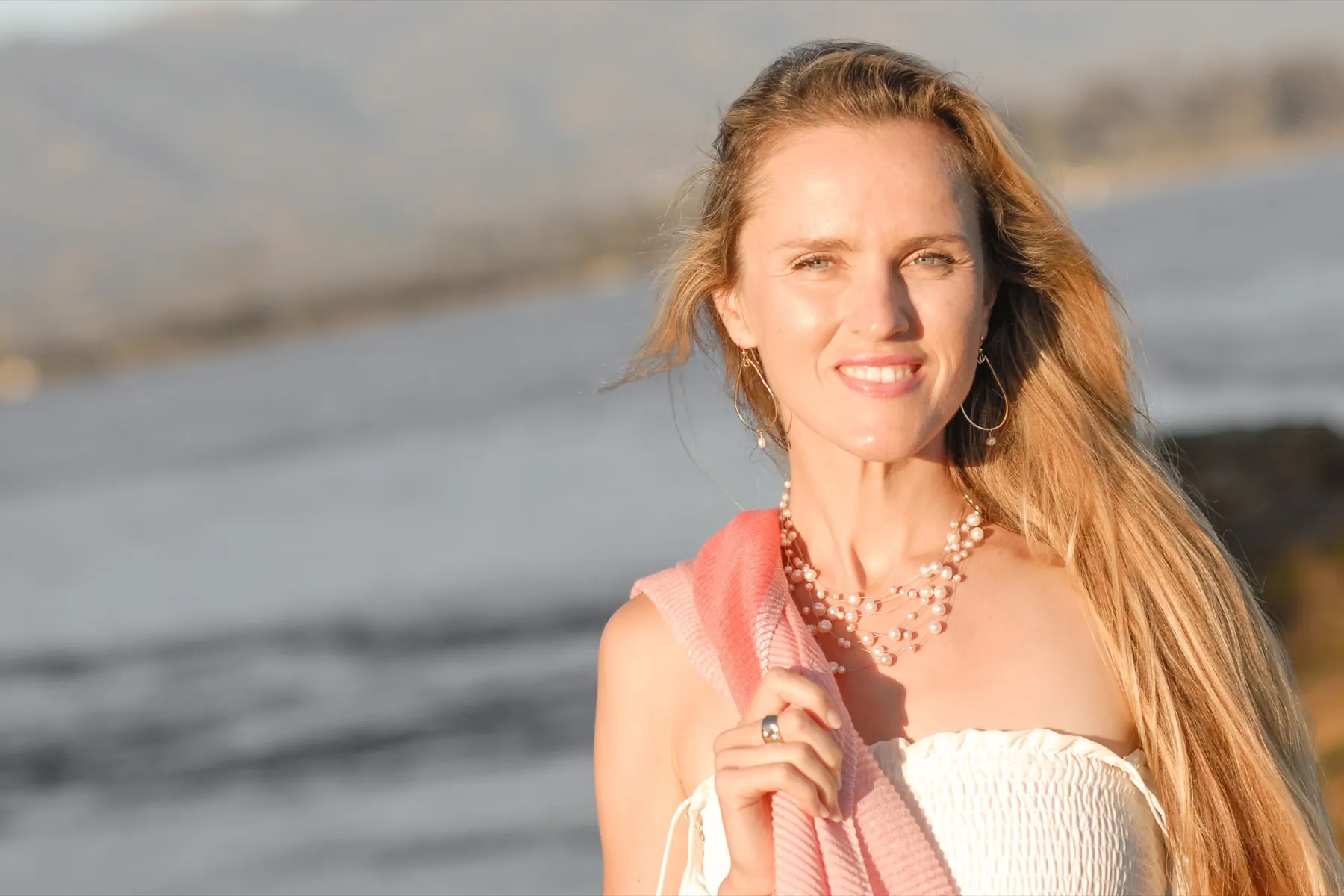 Maria Blair smiling at golden hour by the water